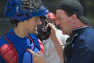 Baseball catcher arguing with umpire.