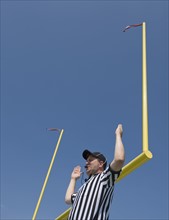 Football referee calling field goal.