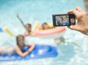 Person photographing girls in swimming pool. Date : 2008