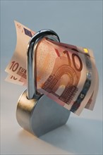 Close up lock and paper euros. Date : 2008