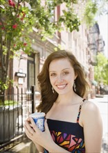 Woman drinking coffee in urban setting. Date : 2008