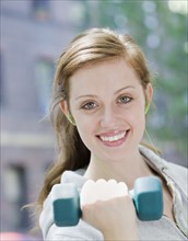 Young woman lifting hand weights. Date : 2008