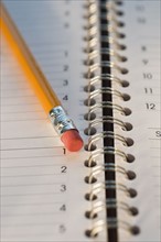 Close up of pencil and notebook. Date : 2008