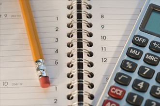 Close up of pencil, notebook and calculator. Date : 2008