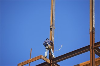 Low angle view of construction worker on beam. Date : 2008