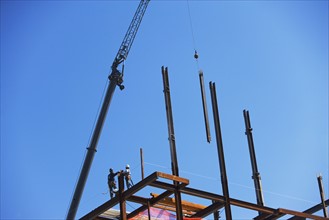 Low angle view of construction workers on beam. Date : 2008