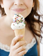 Teenage girl eating ice cream cone. Date : 2008
