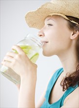 Teenage girl drinking refreshing lime water. Date : 2008