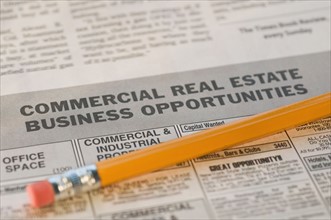 Close up of pencil and real estate newspaper ads. Date : 2008