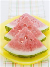 Sliced watermelon stacked in a row. Date : 2008
