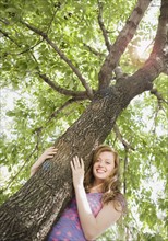 Low angle view of woman hugging tree. Date : 2008