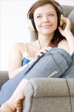 Teenage girl listening to music. Date : 2008