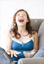 Excited teenage girl tossing cereal in air. Date : 2008