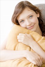 Teenage girl hugging pillow. Date : 2008
