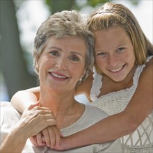 Grandmother and granddaughter posing together.