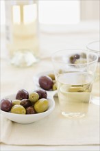Serving bowl of assorted olives and wine. Date : 2008