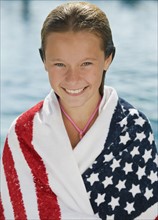 Girl wrapped in American flag towel.