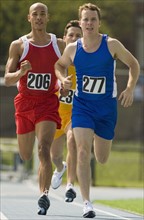 Runners racing on track.