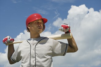 Baseball player holding bat.