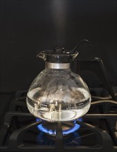 Close up of water boiling on stove.