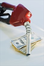 Close up of gas pump and money.