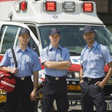 EMT’s posing in front of ambulance.
