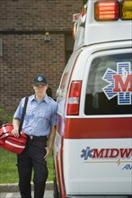 EMT posing in front of ambulance.