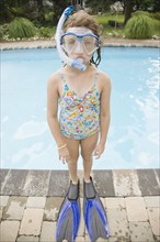 Girl in snorkeling gear standing at edge of swimming pool. Date : 2008
