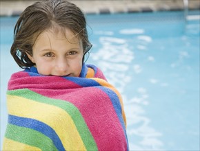Girl wrapped in a towel at edge of swimming pool. Date : 2008