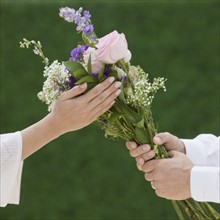 Man giving woman bouquet of flowers.