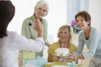 Senior women celebrating friend’s birthday .
