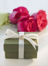 Close up of gift box and flowers.
