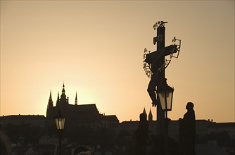 Silhouetted crucifix and cathedral.