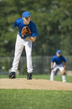 Baseball pitcher preparing to pitch ball.