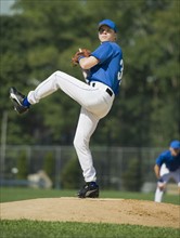 Baseball pitcher preparing to pitch ball.