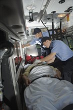 EMT’s caring for patient in ambulance.