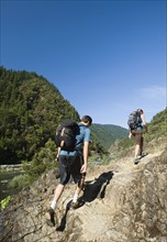 Hikers walking on riverside trail. Date : 2008