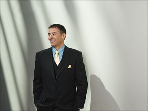 Businessman standing with hands in pockets. Date : 2008