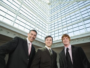 Businessmen posing in convention center atrium. Date : 2008