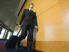 Businessman pulling suitcase. Date : 2008