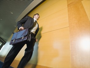 Businessman running in corridor. Date : 2008