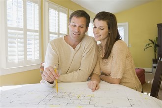 Couple reviewing house blueprints. Date : 2008