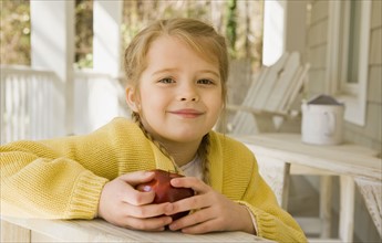 Girl eating apple porch. Date : 2008