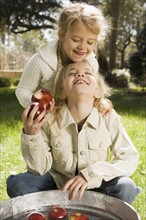 Sisters bobbing for apples. Date : 2008