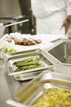 Chef preparing food in commercial kitchen. Date : 2008