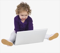 Preschool girl playing with laptop. Date : 2008