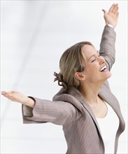 Happy businesswoman celebrating with arms outstretched. Date : 2008