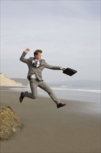 Businessman jumping on beach. Date : 2008