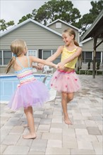 Girls in tutus playing by swimming pool. Date : 2008