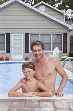 Father and son posing in swimming pool. Date : 2008